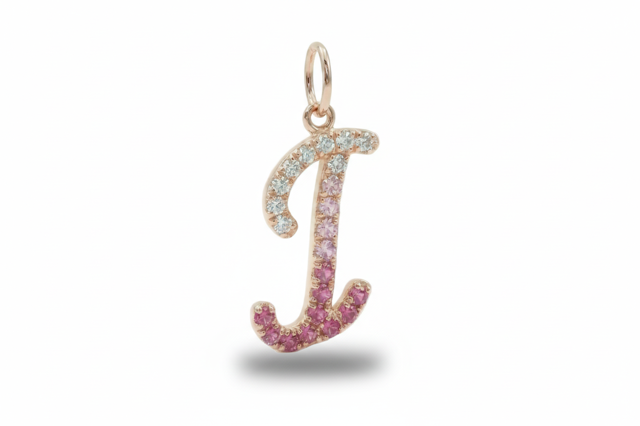 Gold pendant with pink gemstones on a white background