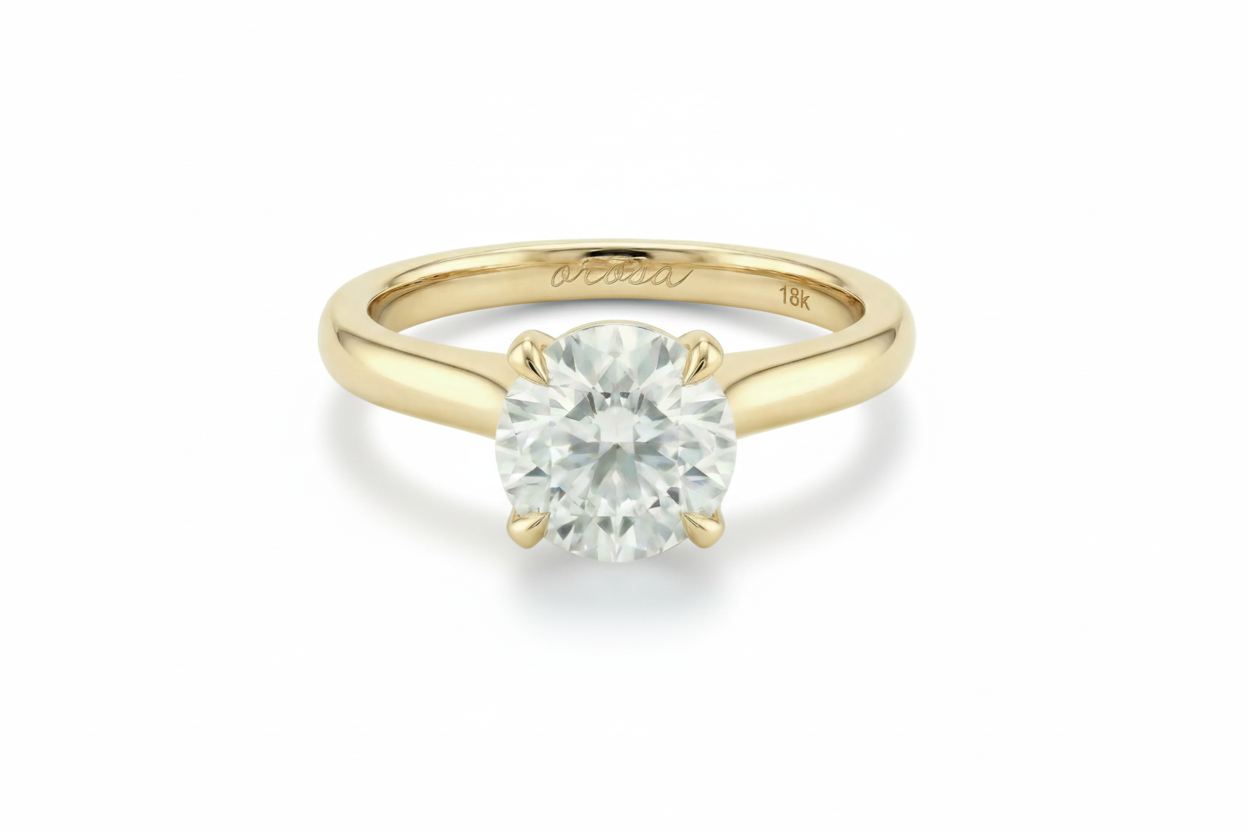 Gold ring with a diamond on a light beige background