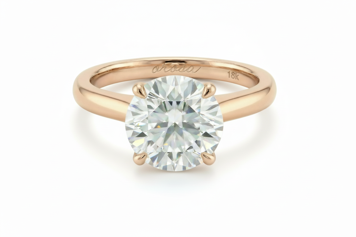 Rose gold ring with a large diamond on a white background