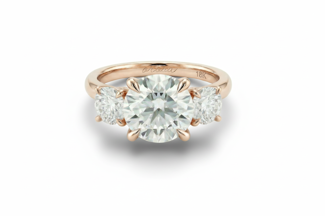 Rose gold diamond ring with a large central gemstone and smaller stones on a light background