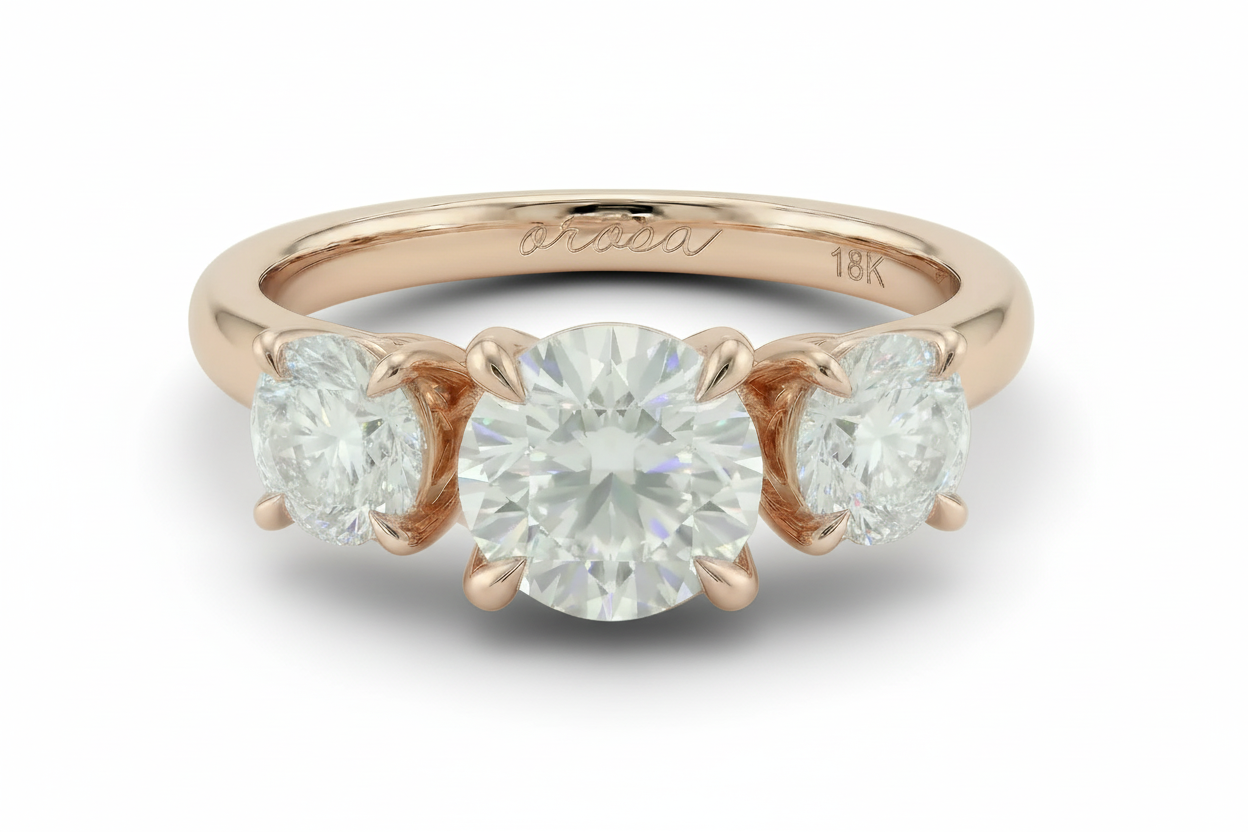 Rose gold ring with three diamonds on a white background