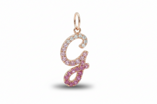 Gold and pink letter 'G' pendant on a white background