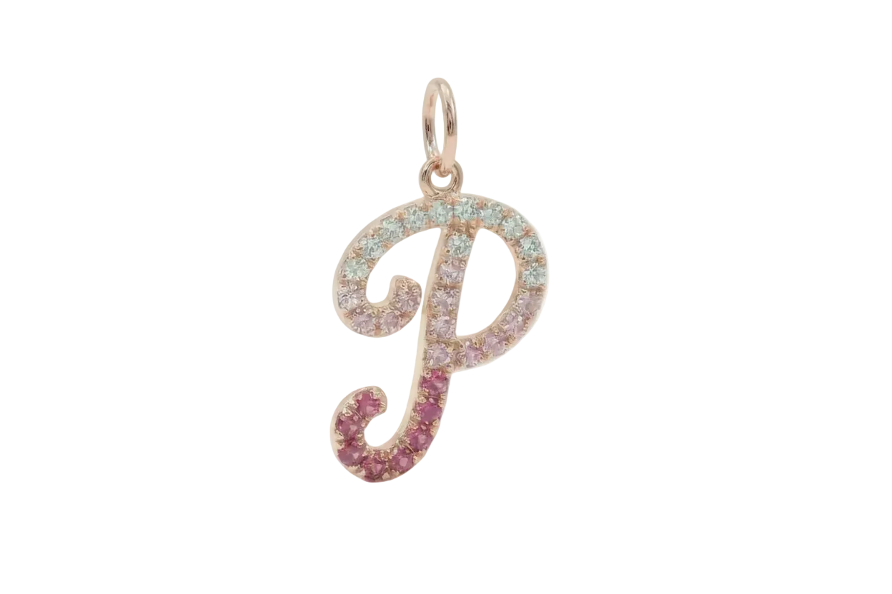 Gold letter 'P' pendant with gemstones on a white background