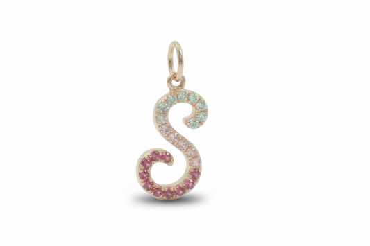 Pendant shaped like the letter 'S' with colorful gemstones on a light background