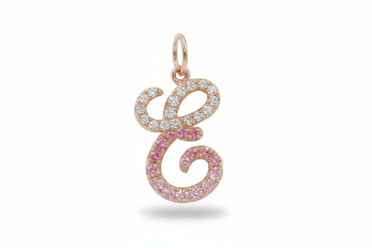 Rose gold and pink gemstone pendant on a white background